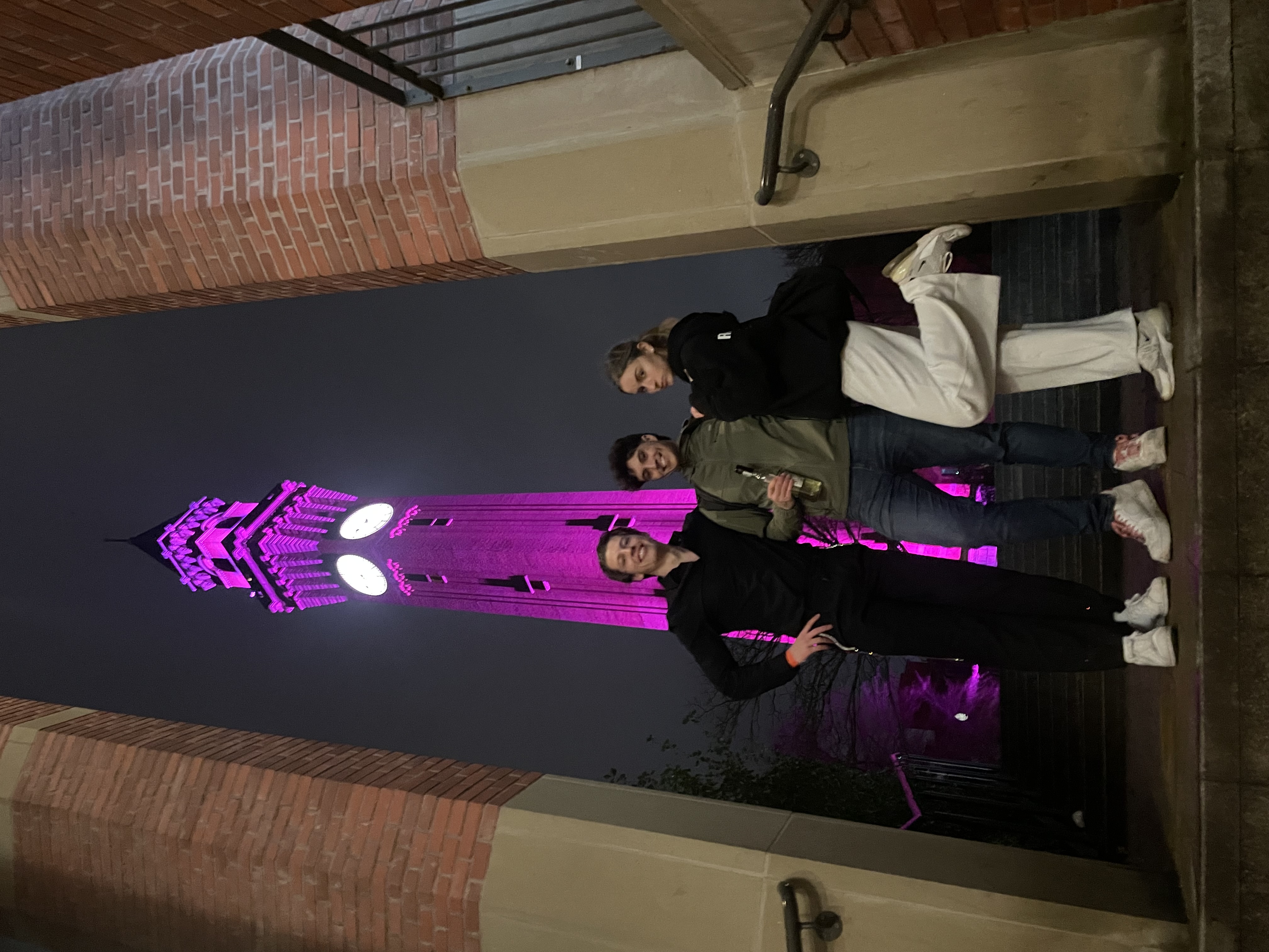 Gabriel with friends by a lit-up clock tower