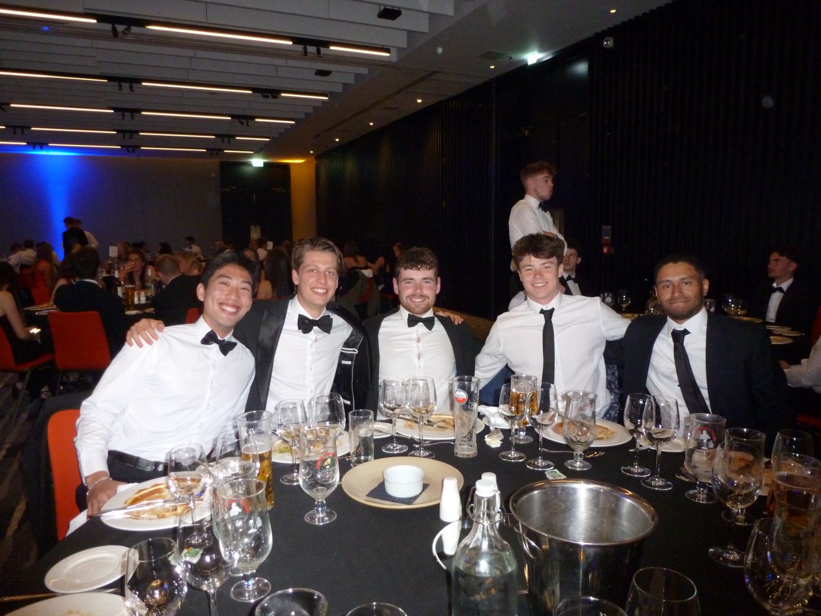Gabriel with friends at a black-tie dinner