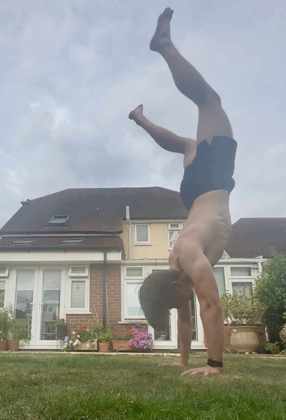 Gabriel doing a handstand in the garden